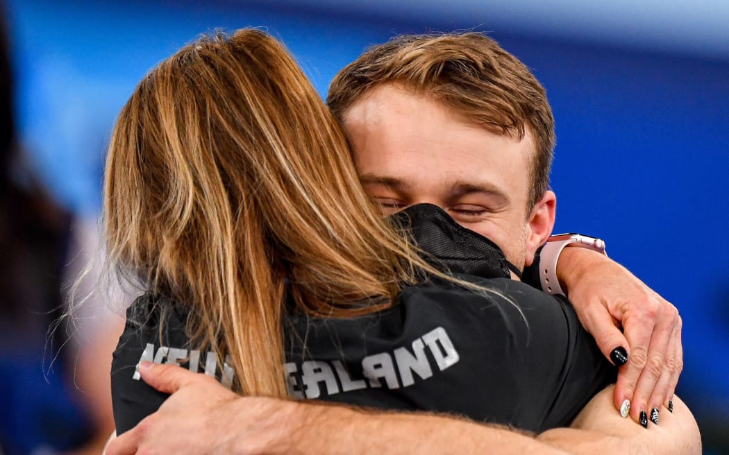 Dylan Schmidt hugs coach Angie Dougal after winning bronze at Tokyo Olympics.