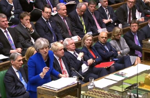 UK Prime Minister Theresa May gesturing as she speaks during the weekly Prime Ministers Questions session in the House of Commons.