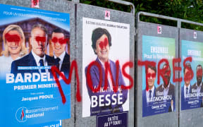 France, Montaigu-Vendee, 2024-07-05. Tagged and defaced campaign posters a few days before the second round of the legislative elections: Rassemblement National candidate Jacques Proux alongside Jordan Bardella and Marine Le Pen, and outgoing right-wing MP Caroline Besse. Political illustration, legislative election. Photograph by Mathieu Thomasset / Hans Lucas.
France, Montaigu-Vendee, 2024-07-05. Affiches taguees et degradees de campagne a quelques jours du second tour des elections legislatives : le candidat du Rassemblement National Jacques Proux aux cotes de Jordan Bardella et Marine Le Pen, la depute sortante divers droite Caroline Besse. Illustration politique, election legislative. Photographie de Mathieu Thomasset / Hans Lucas. (Photo by Mathieu Thomasset / Hans Lucas / Hans Lucas via AFP)