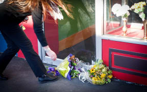 A Waimate resident paying tribute to the  Kafle family outside their restaurant, Everest Indian Restaurant.