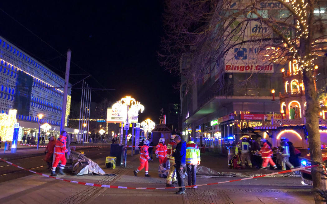 Police and rescue personnel cordon off the area next to a Christmas market, where a car crashed into a crowd killing and injuring people, according to media, on December 12, 2024 in Magdeburg. (Photo by Doerthe HEIN / DPA / AFP) / Germany OUT / GERMANY OUT
