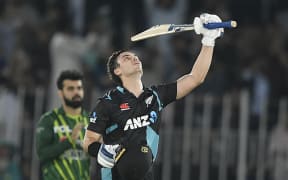 New Zealand's Mark Chapman celebrates after scoring a century during the fifth and final Twenty20 international cricket match between Pakistan and New Zealand at the Rawalpindi Cricket Stadium, 2023.