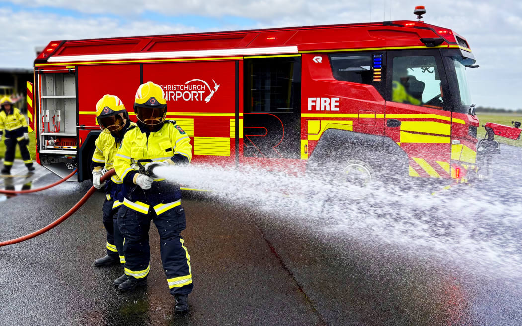 Firefighters at Christchurch Airport drill with their new electric fire truck.