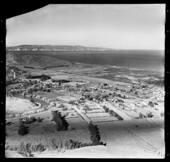 An aerial view during the 1950s of Nuhaka, with the Mahia Peninsula in the distance
