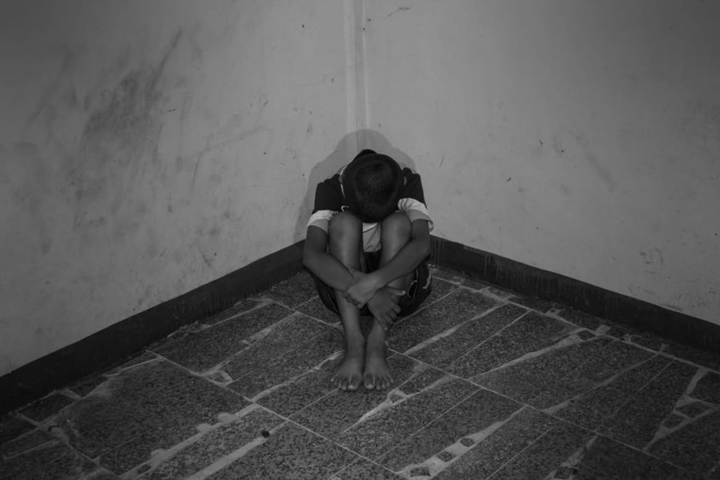 Child with head in hands