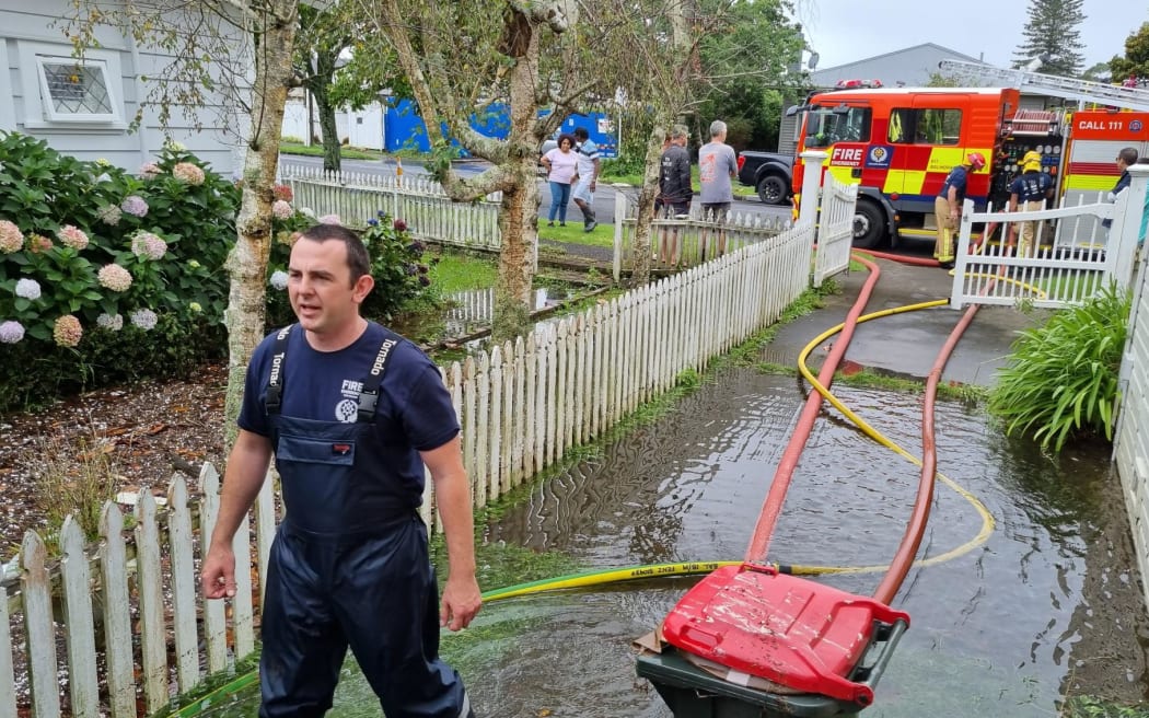 Floodwaters are pumped out of a home on Wairere Rd in Mount Albert by Fire and Emergency.