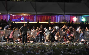 People run from the Route 91 Harvest country music festival.