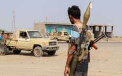 Forces loyal Yemen's Saudi-backed government stand near a pick-up truck in the Hays district, south of Hodeidah on September 5, 2026. Fighting between Yemen's Saudi-backed government forces and the country's Houthi rebels killed more than 60 people on September 5, including civilians, medical and military sources told AFP. Fighting erupted on September 3, 2026, after the Iran-backed Houthis launched a ground assault along with rocket and drone attacks near coastal areas, vying for control of the narrow Bab al-Mandab strait at the Red Sea's southern entrance. (Photo by Khaled ZIAD / AFP)
