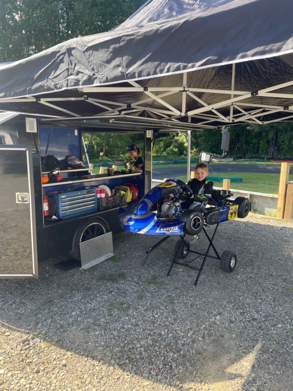 Sebastian Grant with his kart and a trailer that acts a mobile mechanic workshop.