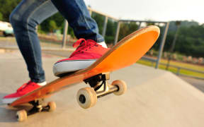 A person skateboarding at a skate park.