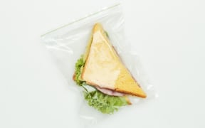 A ziploc bag with a tasty sandwich inside.