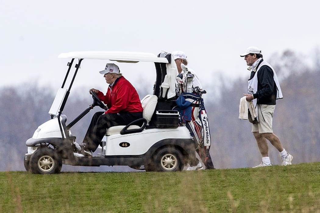 STERLING, VIRGINIA - NOVEMBER 21: US President Donald Trump golfs at Trump National Golf Club on November 21, 2020in Sterling, Virginia.