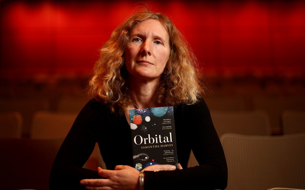 British writer and Booker Prize 2024 shortlisted author Samantha Harvey poses with her book 'Orbital' during the Booker Prize 2024 Award photo call event, at the Southbank centre, in central London, on 11 November, 2024.