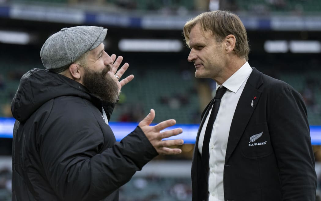 Joe Marler of England speaks with All Blacks Head Coach Scott Robertson.