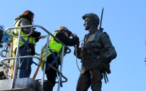 Art restoration team Carolina Izzo, right, and Maria Pagu at work on the cenotaph at Masterton's Queen Elizabeth Park