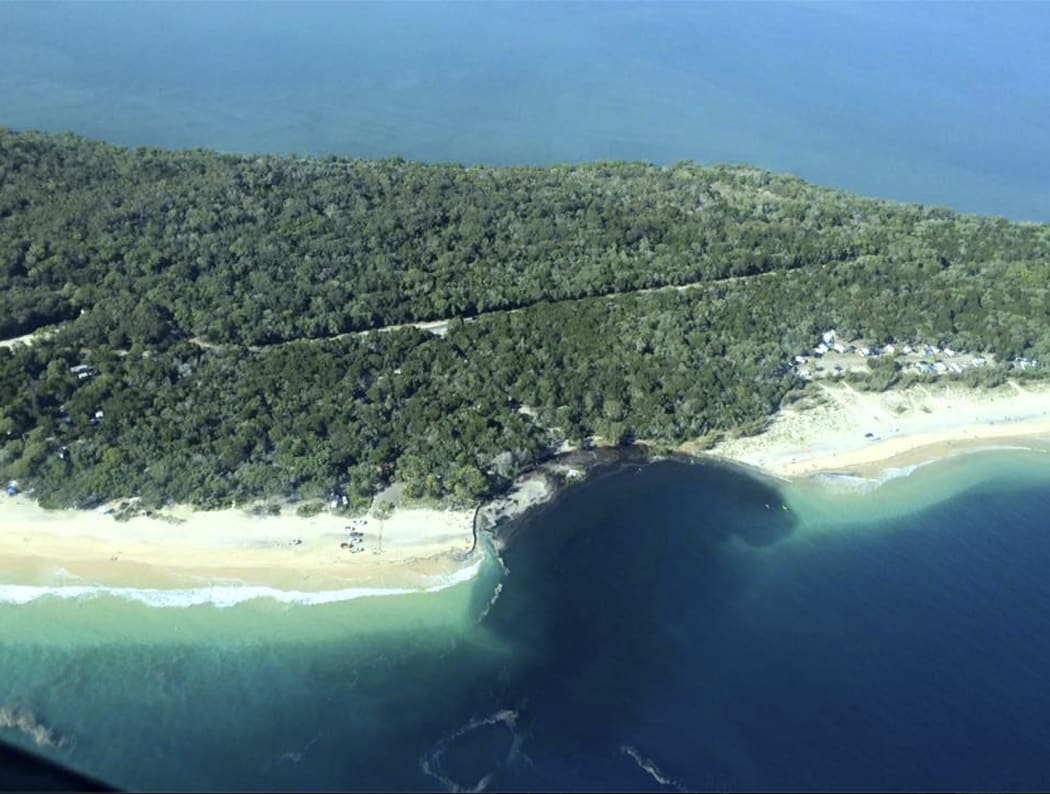 A sinkhole swallowed vehicles at a campsite near Queensland's Rainbow Beach.

AAP / Higgins Storm Chasing
