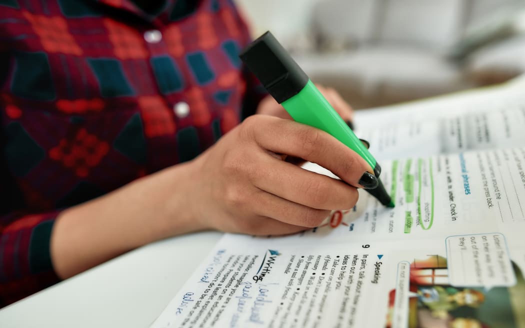 Cropped shot of a female student learning English.