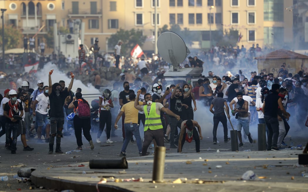 Lebanese protesters clash with security forces in downtown Beirut on August 8, 2020, following a demonstration against a political leadership they blame for a monster explosion that killed more than 150 people and disfigured the capital Beirut.
