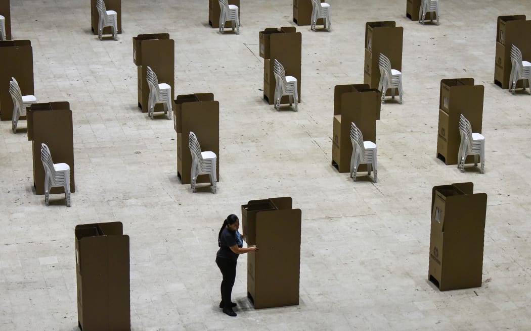 A worker assembles voting booths at a polling station in Cali, Colombia