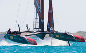 Emirates Team New Zealand rounds the top mark ahead of Oracle Team USA in race four on day two of the America's Cup.