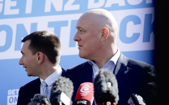 National Party leader Christopher Luxon and MP Simeon Brown react to heckler during press conference in Auckland on 28 August, 2023.