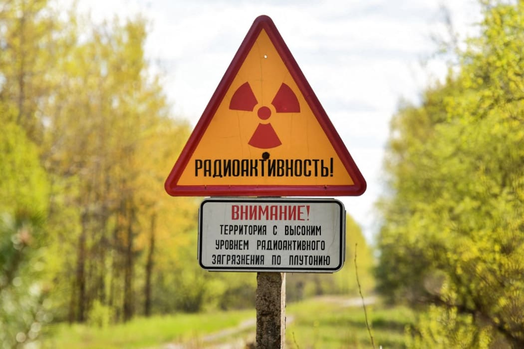A sign of radioactive danger is pictured at the entrance of the abandoned village of Babchin, outside the 30-km exclusion zone around the Chernobyl nuclear reactor, some 370 km southeast of Minsk, Belarus.