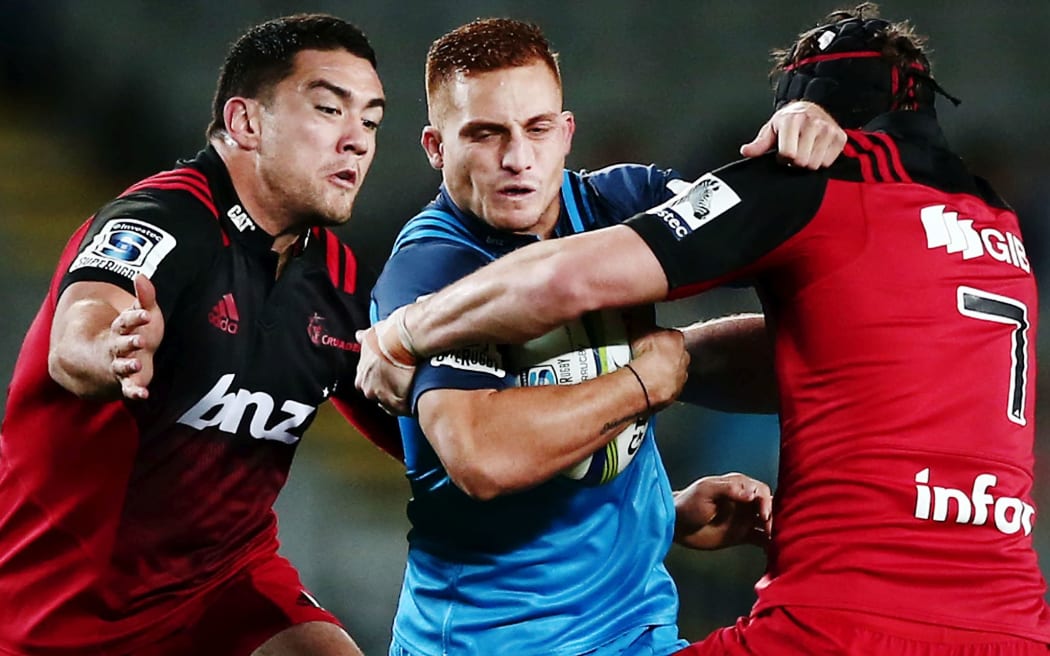 Ihaia West of the Blues charges into Codie Taylor and Matt Todd.