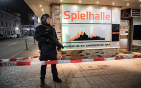 A police officer secures an area in the immediate vicinity of the crime scene in Hanau.
