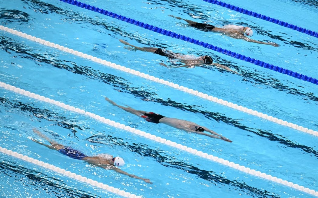 (From L) US' Carson Foster, Canada's Finlay Knox, New Zealand's Lewis Clareburt and Turkey's Berke Saka compete in a heat of the men's 200m individual medley swimming event during the Paris 2024 Olympic Games at the Paris La Defense Arena in Nanterre, west of Paris, on August 1, 2024. (Photo by Jonathan NACKSTRAND / AFP)