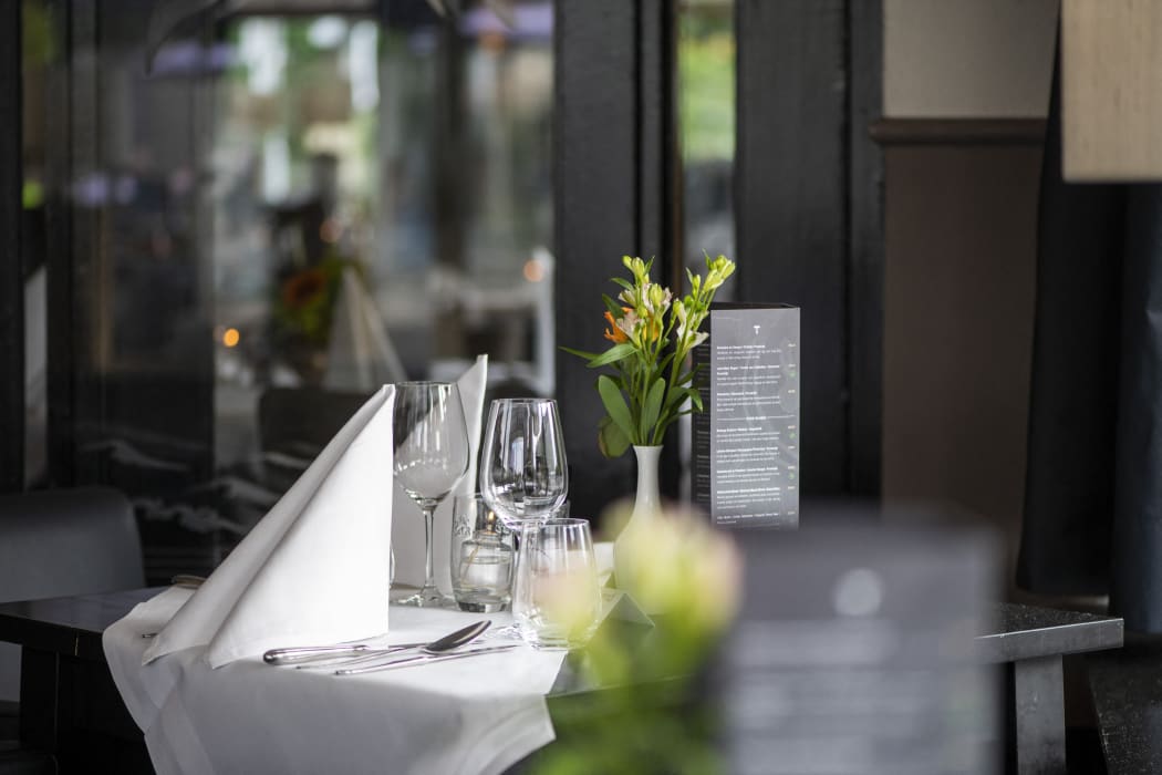 Elegant table setting at a sidewalk cafe, awaiting guests. (Photo by Pancake Pictures / Image Source / Image Source via AFP)