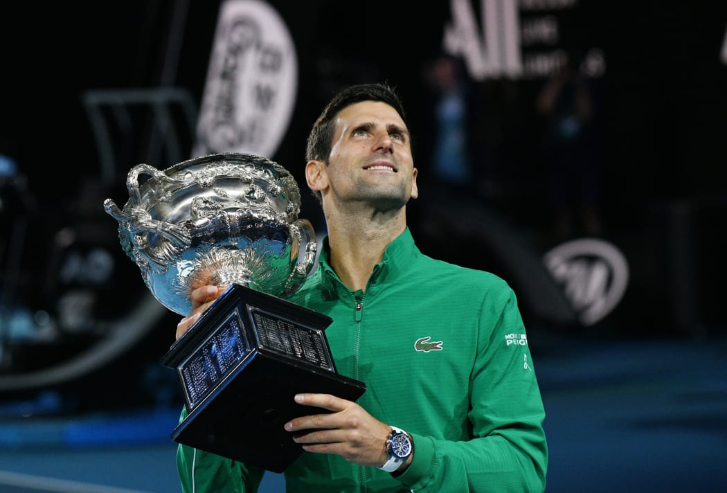 Novak Djokovic of Serbia holds the Australian Open winners trophy.