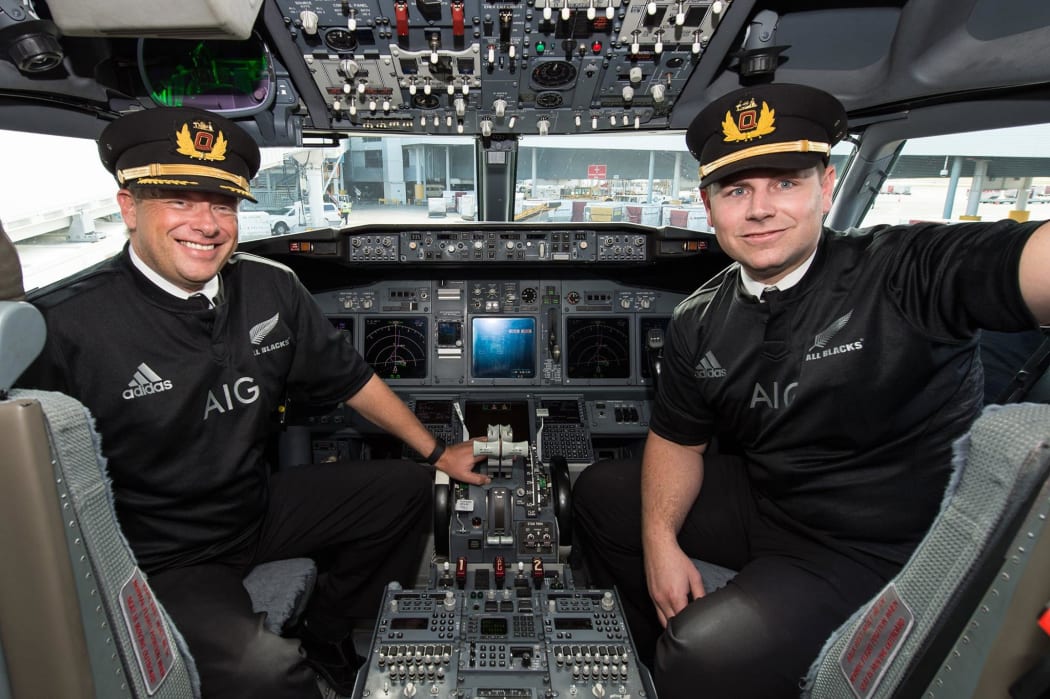Pilots on a Sydney-to-Auckland flight wearing All Blacks gear after Australia lost to New Zealand in the RWC 2015 final - and Qantas lost a bet to Air New Zealand.