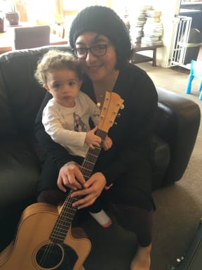 Puawai Cairns with Betty the Guitar and her pēpi, Awhiorangi.