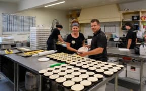 Sheffield Pie Shop owners Loretta and Shane Paterson prepare some of the more than 3000 pies the shop has pumped out since reopening after the Christmas break on Wednesday. The business is on the market for the first time in twenty years.