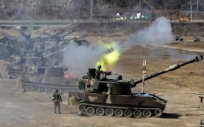 South Korean army K-55 self-propelled howitzers participate in a live fire drill during the annual South Korea-Us joint maneuvers, known as Foal Eagle, near Rodriguez Range in Pocheon, south of the demilitarized zone that divides the two Koreas, on March 15, 2012.