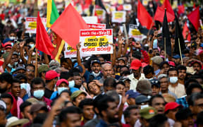 Janatha Vimukthi Peramuna party activists and supporters shout anti-government slogans during a demonstration in Colombo on April 19, 2022.
