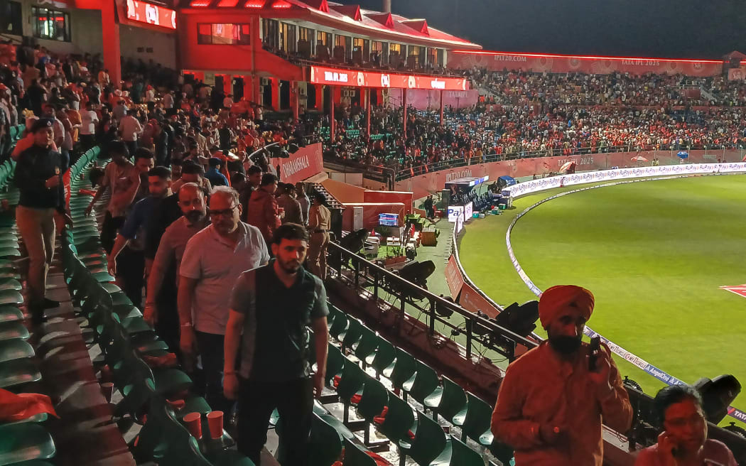 Spectators leave after the Indian Premier League (IPL) Twenty20 cricket match between Punjab Kings and Delhi Capitals was abandoned due to the floodlights malfunctioning at the Himachal Pradesh Cricket Association Stadium in Dharamsala, 8 May, 2025.