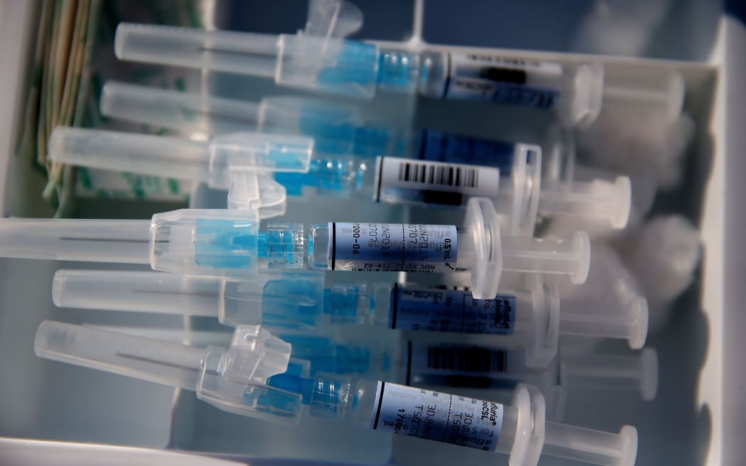 Syringes filled with flu vaccine (California).