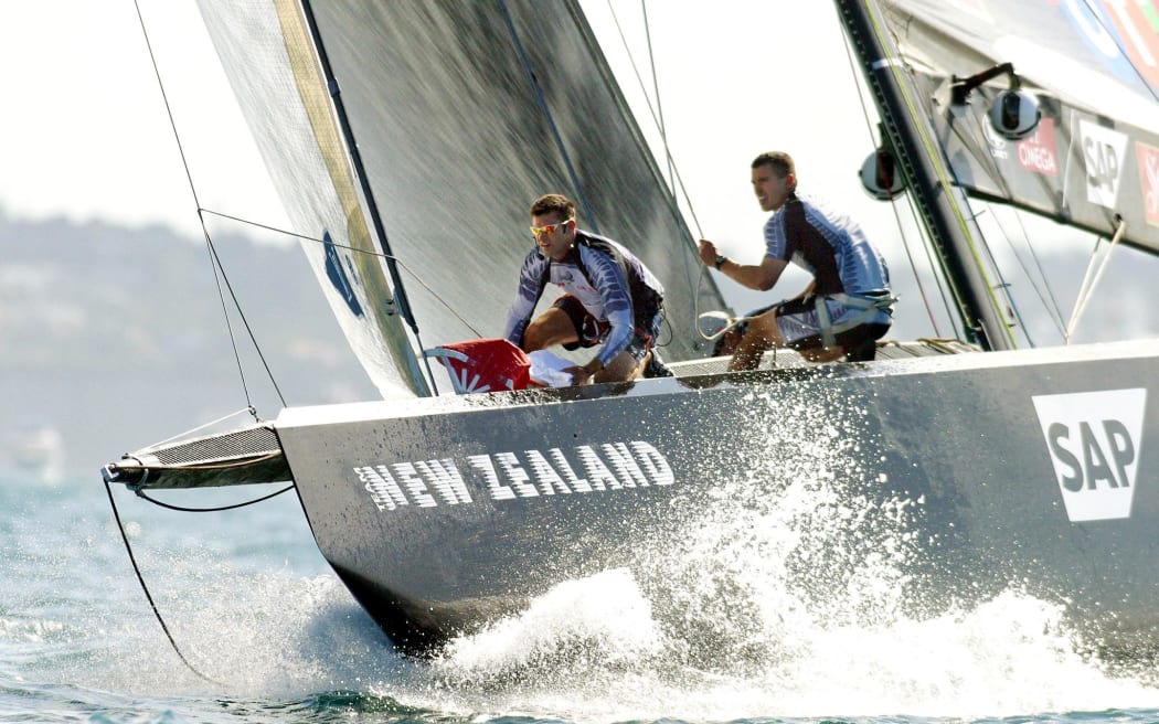 Matt Mitchell, right, with Jeremy Lomas on the bow of Team New Zealand's NZL-82 boat during one of their races against Alinghi in the 2003 America's Cup in Auckland, 16 February 2003.