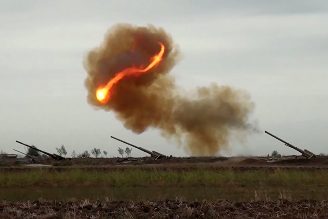 An image grab taken from a video made available by the Azerbaijani Defence Ministry on September 28, 2020, allegedly shows an Azeri artillery strike towards the positions of Armenian separatists in the breakaway region of Nagorno-Karabakh.