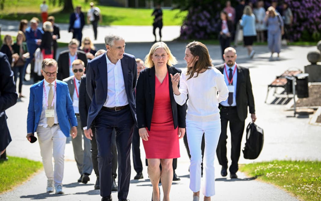 Finland's Prime Minister Sanna Marin (R), Sweden's Prime Minister Magdalena Andersson and Norway's Prime Minister Jonas Gahr Store chat as they are on their way to attend the SAMAK's summit titled "Our Nordic region can do better", outside Stockholm, Sweden, on June 14, 2022. - SAMAK is the Cooperation Committee of the Nordic Labour Movement, an alliance of social democratic parties and labour councils in the Nordic countries. (Photo by Henrik MONTGOMERY / TT NEWS AGENCY / AFP) / Sweden OUT