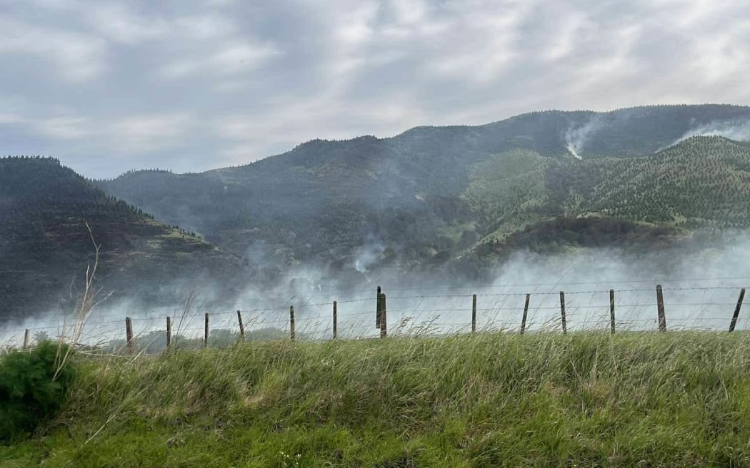 fire crews work to try and contain a huge bush fire near Porangahau.