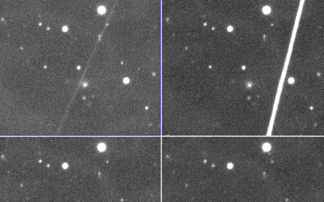 Black and white image of Comet C/2014 UN271 (Bernardinelli-Bernstein) and some light streaks left by satellites in the image