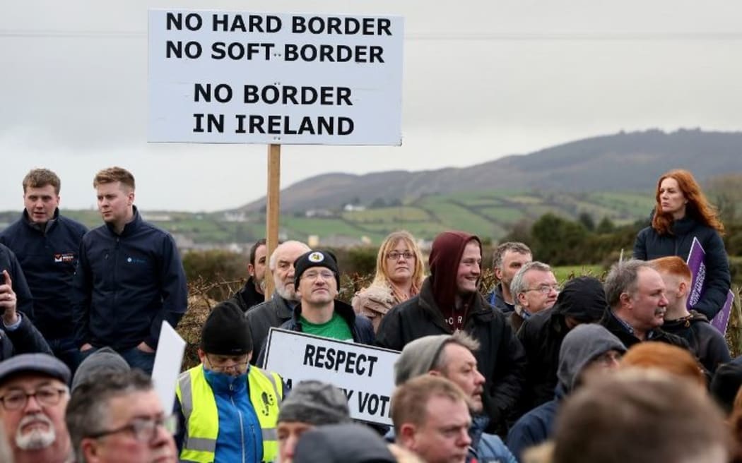 Brexit activists hold placards as they attend a demonstration by the anit-brexit campaign group "Border communities against Brexit", a road crossing the border between Northern Ireland and Ireland in Newry, Northern Ireland, on January 26, 2019.