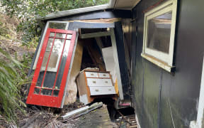 The bach was knocked off its foundations by a wall of mud and debris.