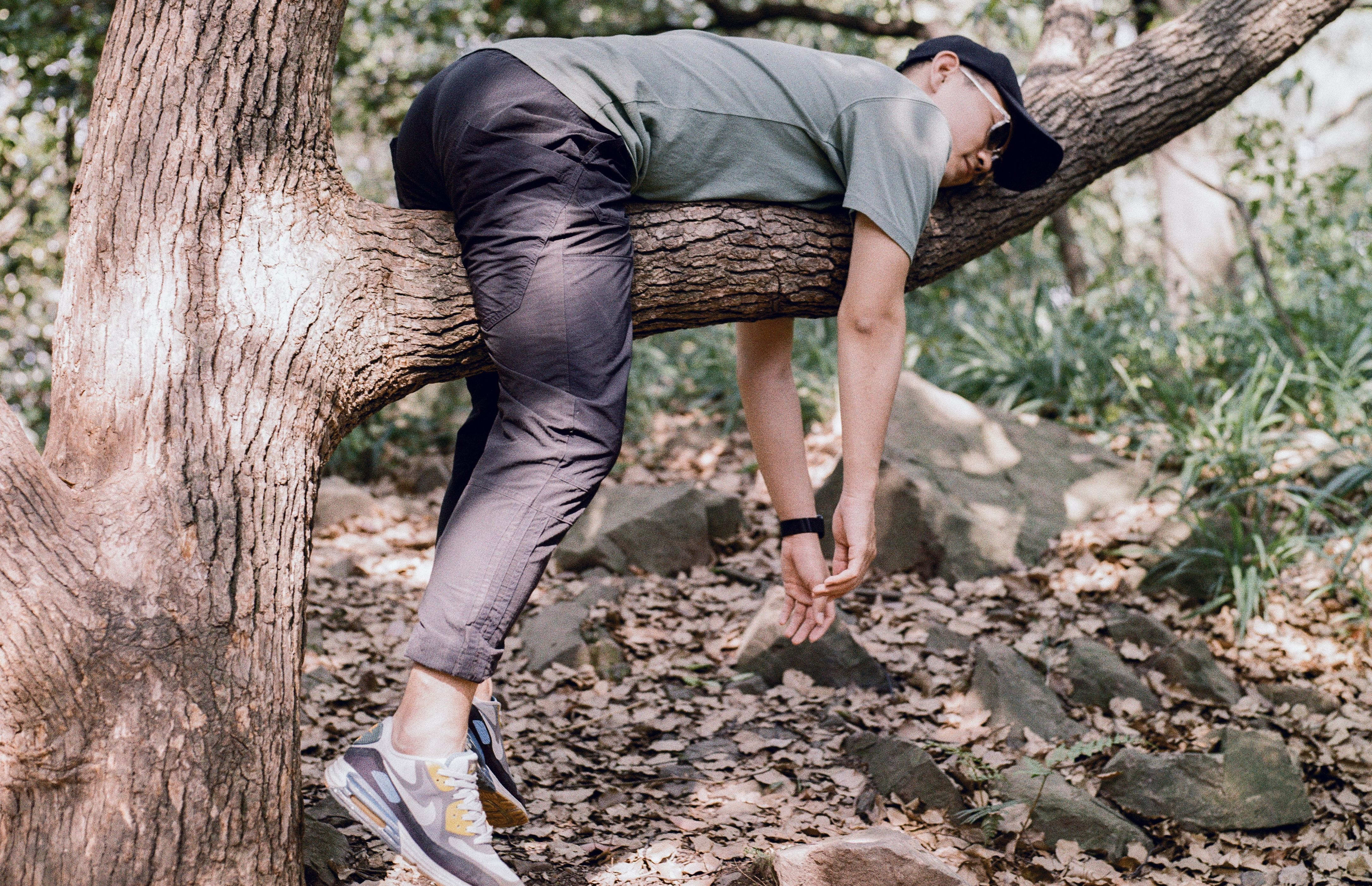man resting on tree