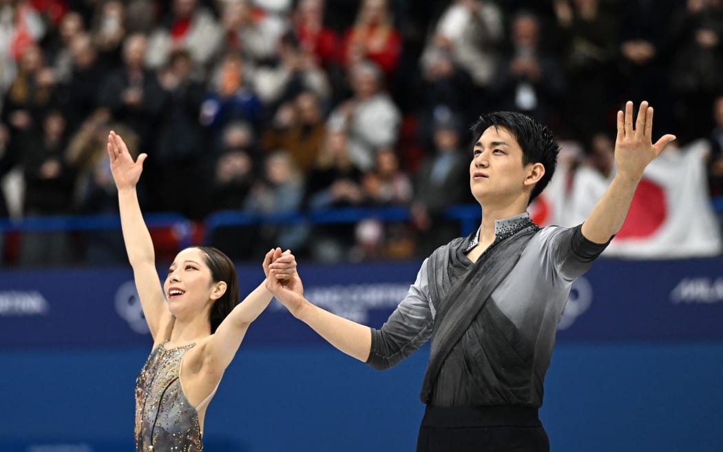 Gold medallists Japan's Riku Miura and Japan's Ryuichi Kihara arrive on the ice for the podium ceremony in the figure skating pair skating free skating final during the Milano Cortina 2026 Winter Olympic Games at Milano Ice Skating Arena in Milan on February 16, 2026. (Photo by Gabriel BOUYS / AFP)