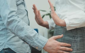 Sexual harassment at work. Boss touching his secretary in office.