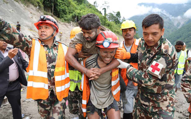 This handout photograph taken and released by the Nepal Army on September 4, 2026 shows army personnel carrying a worker who was trapped inside a tunnel, during a rescue operation at Trishuli-3A Hydropower Project in Nepal's Rasuwa district. Two hydropower workers were pulled from a tunnel buried by debris in Nepal on September 4, more than a week after catastrophic flooding swept through the area, government ministers said. (Photo by Handout / NEPAL ARMY / AFP) / RESTRICTED TO EDITORIAL USE - MANDATORY CREDIT "AFP PHOTO/Nepal Army/HANDOUT" - NO MARKETING NO ADVERTISING CAMPAIGNS - DISTRIBUTED AS A SERVICE TO CLIENTS