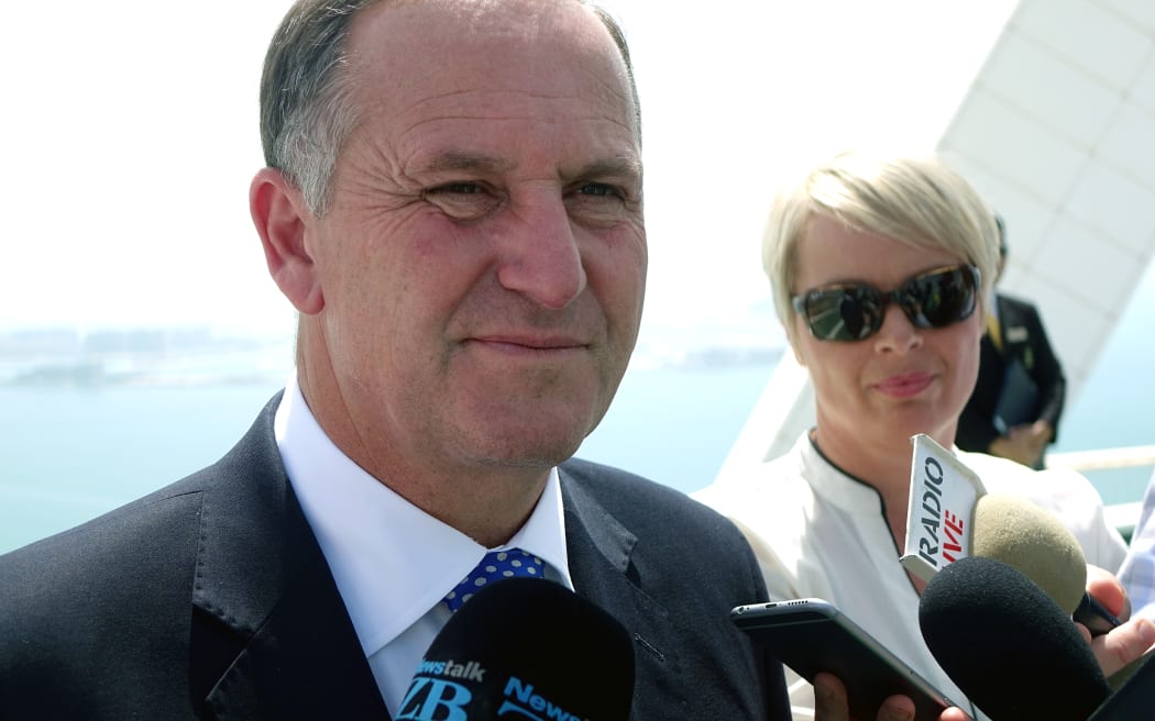 Prime Minister John Key speaks to reporters on the helipad of the Burj Al Arab, the world's only 7 star hotel.